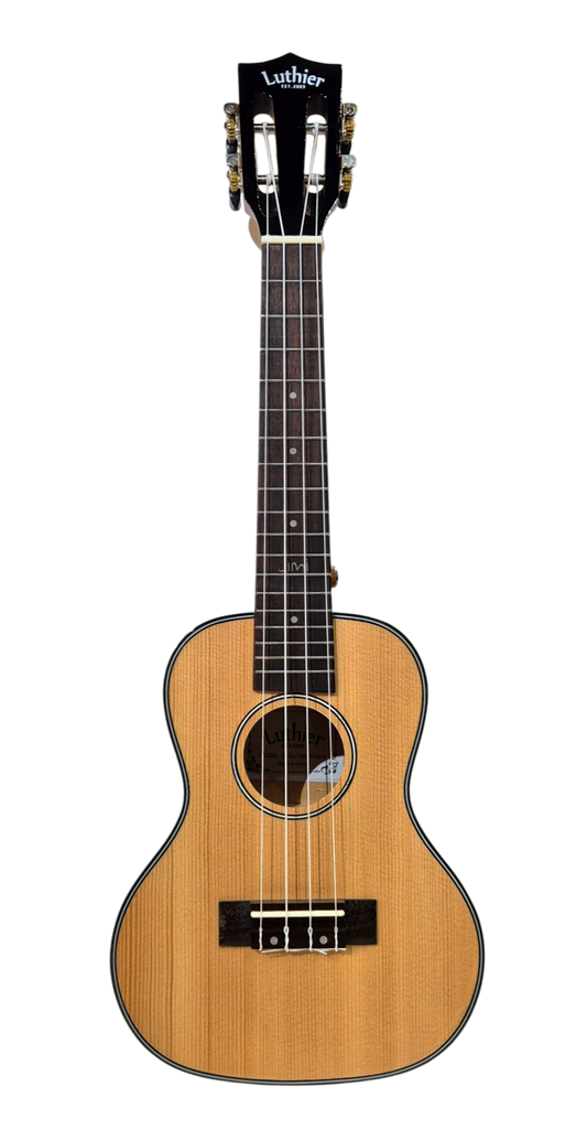 A Luther brand concert ukulele with a natural Quilted Mapple finish, black Slotted-style headstock, and black trim, shown against a solidbackground. Hear the sound & strum it now